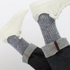Navy marl socks with a striped pattern worn with white sneakers on a white background