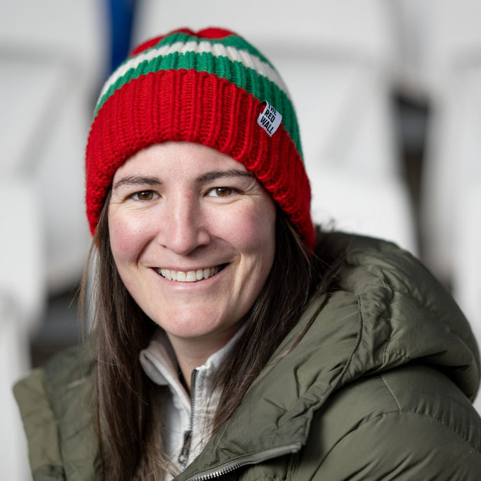 Woman wearing the red wall beanie hat.