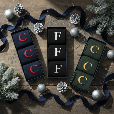 Men's Letter Socks in gift boxes on a festive table.