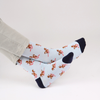 Pale blue socks with skiing squirrel pattern on a white background