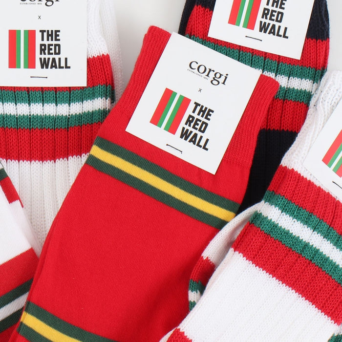 Red socks with green and yellow stripes and 'corgi x The Red Wall' branding.
