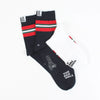 Navy socks with red and green stripes and visible branding on a white background