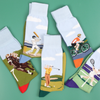 Collection of sports themed socks on a green background.