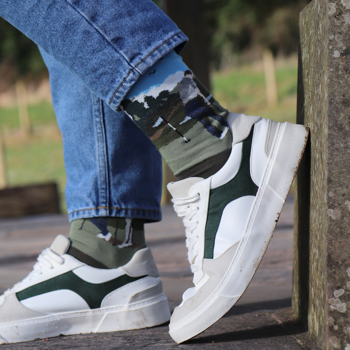 person wearing golfing socks outside with jeans 