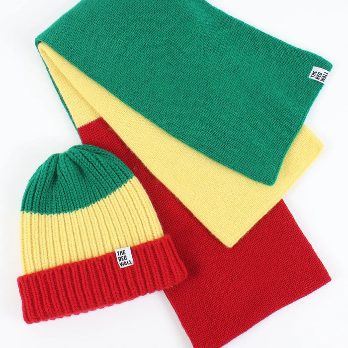 Colorful knit hat with green, yellow, and red stripes on a white background