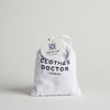 A white cotton sachet labeled 'Protect Me - Clothes Doctor London' containing natural scent bags for wardrobe use.