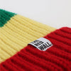 Colorful striped beanie with a label on a white background
