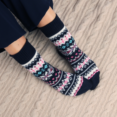 Person wearing patterned socks on a textured surface