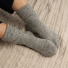 Gray socks worn on a textured surface