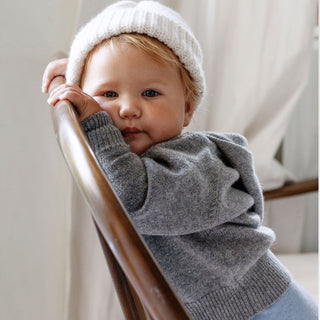 A sumptuous, grey button-down hooded cardigan for baby available in both wool and cashmere is a special treat that every new parent and baby will love, by Corgi Socks.