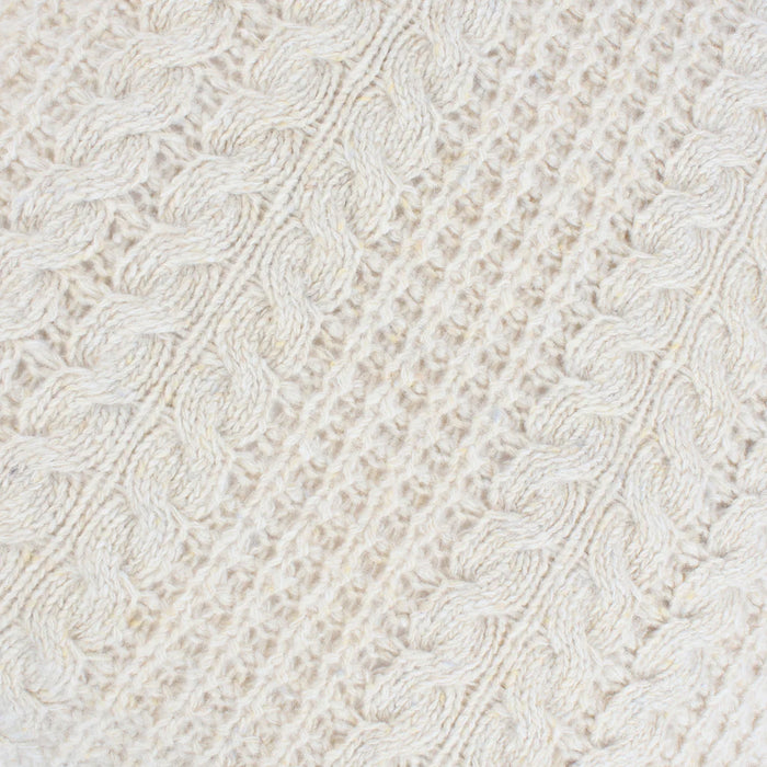 Close-up of a textured white fabric with a cable knit pattern