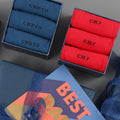 A set of personalised socks in various colors, with each box labeled with a name. The packaging includes a gift box with the word 'BEST' on it.