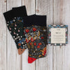 2 pairs of William Morris socks on a wooden background with gift box