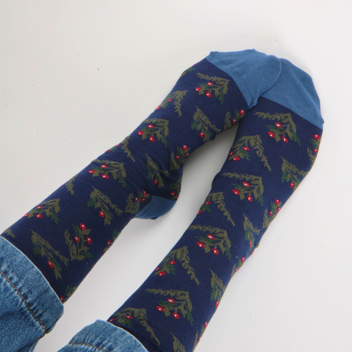 Navy blue socks with holly and berry worn with jeans