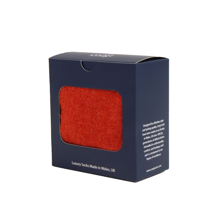 Box of orange gloves with a visible brand name on a white background

