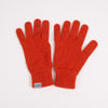Pair of red gloves with a visible brand tag on a white background

