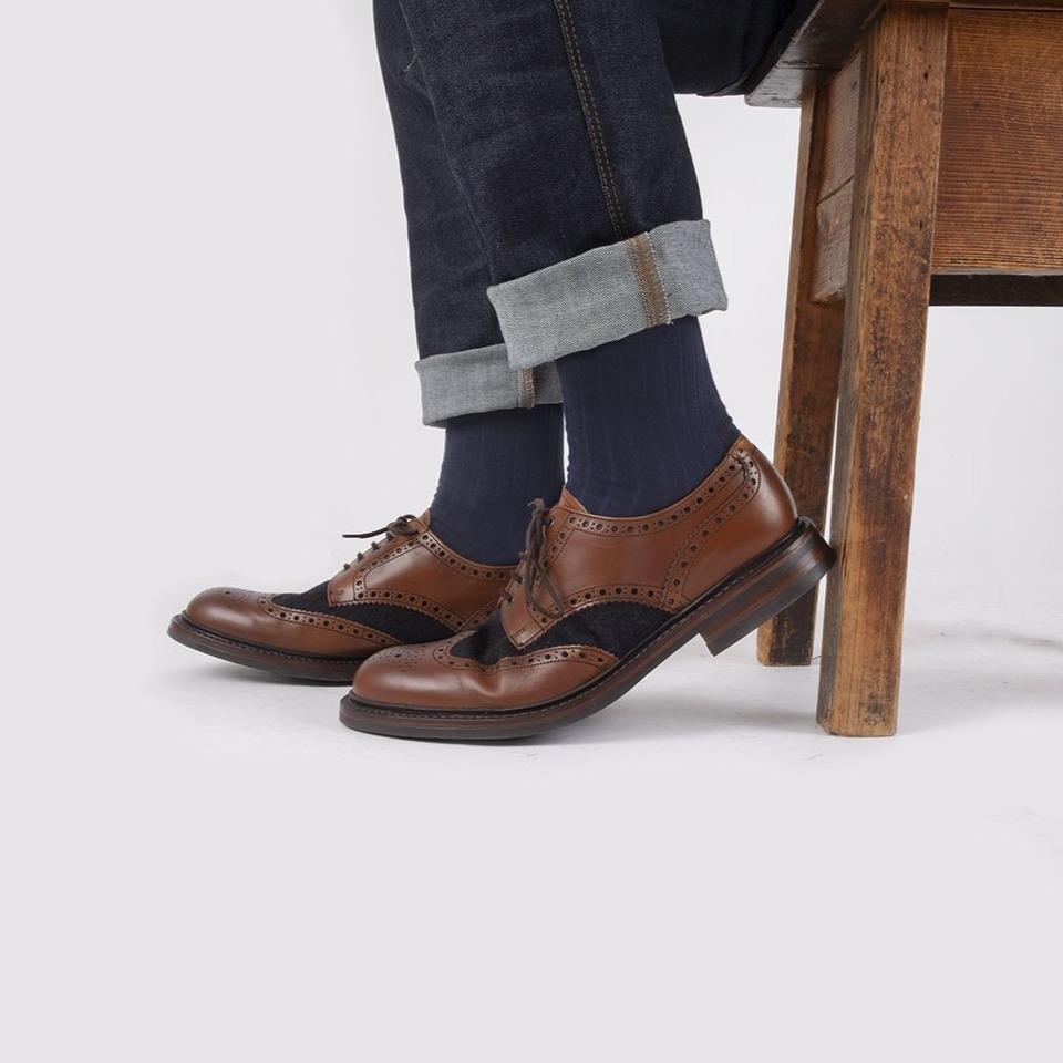 A pair of knitted socks shown flat.