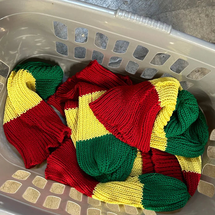 Red Wall knitted items in a laundry basket in the factory.