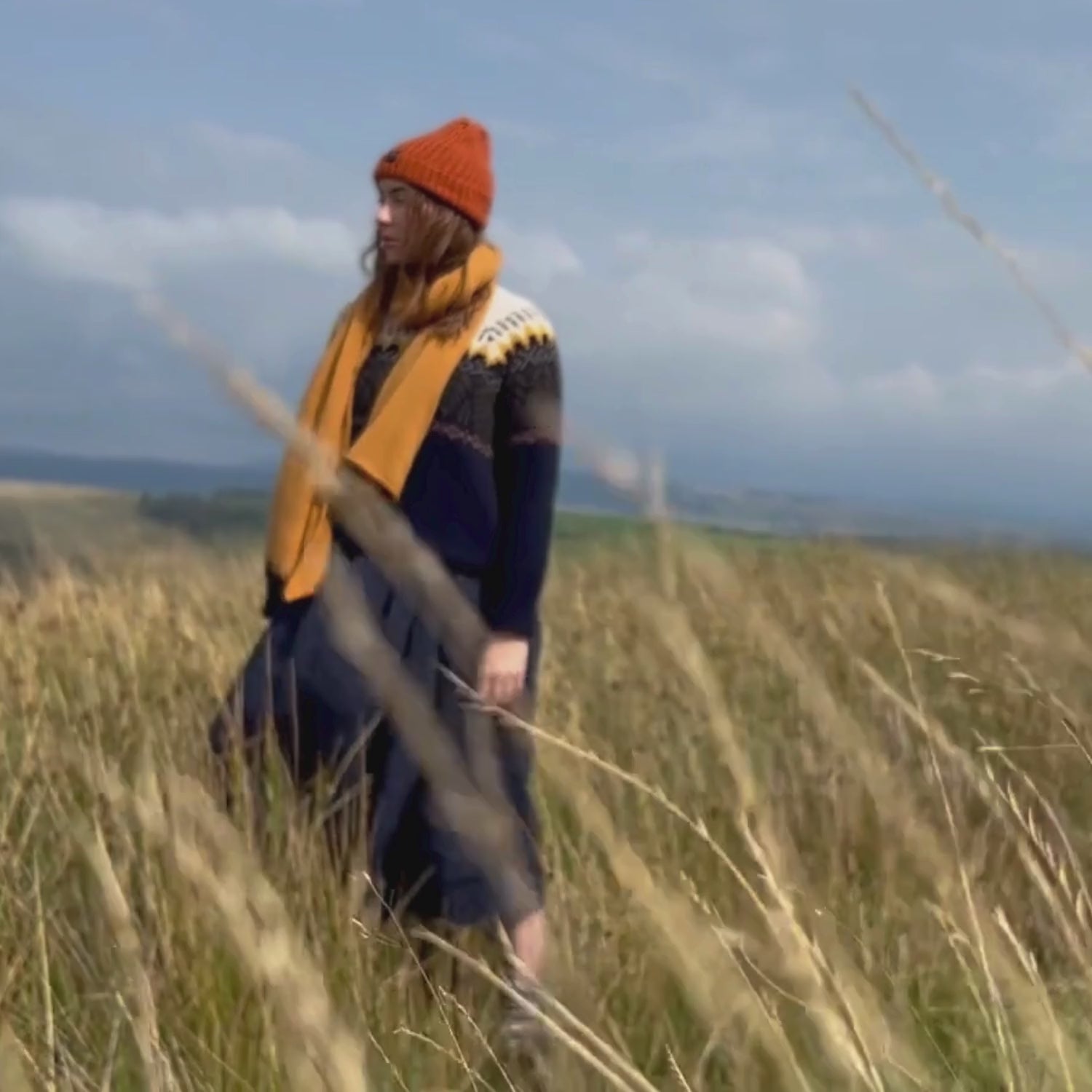 video of woman on the Welsh hills wearing the Donegal beanie hat.