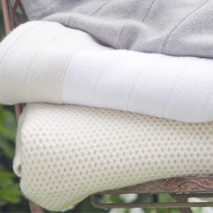 A beautiful white 100% cashmere honeycomb stitch baby blanket would make a perfect gift for a new born baby, by Corgi Socks.