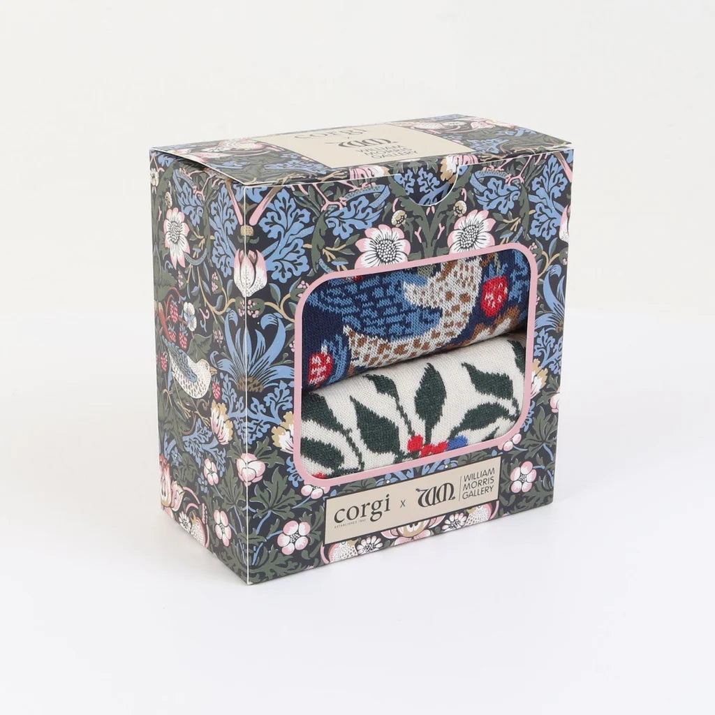 Floral-patterned box containing a knitted item with 'corgi' branding on a white background