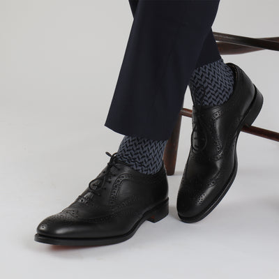 A pair of men's formal socks with a geometric pattern in gray and blue colors.