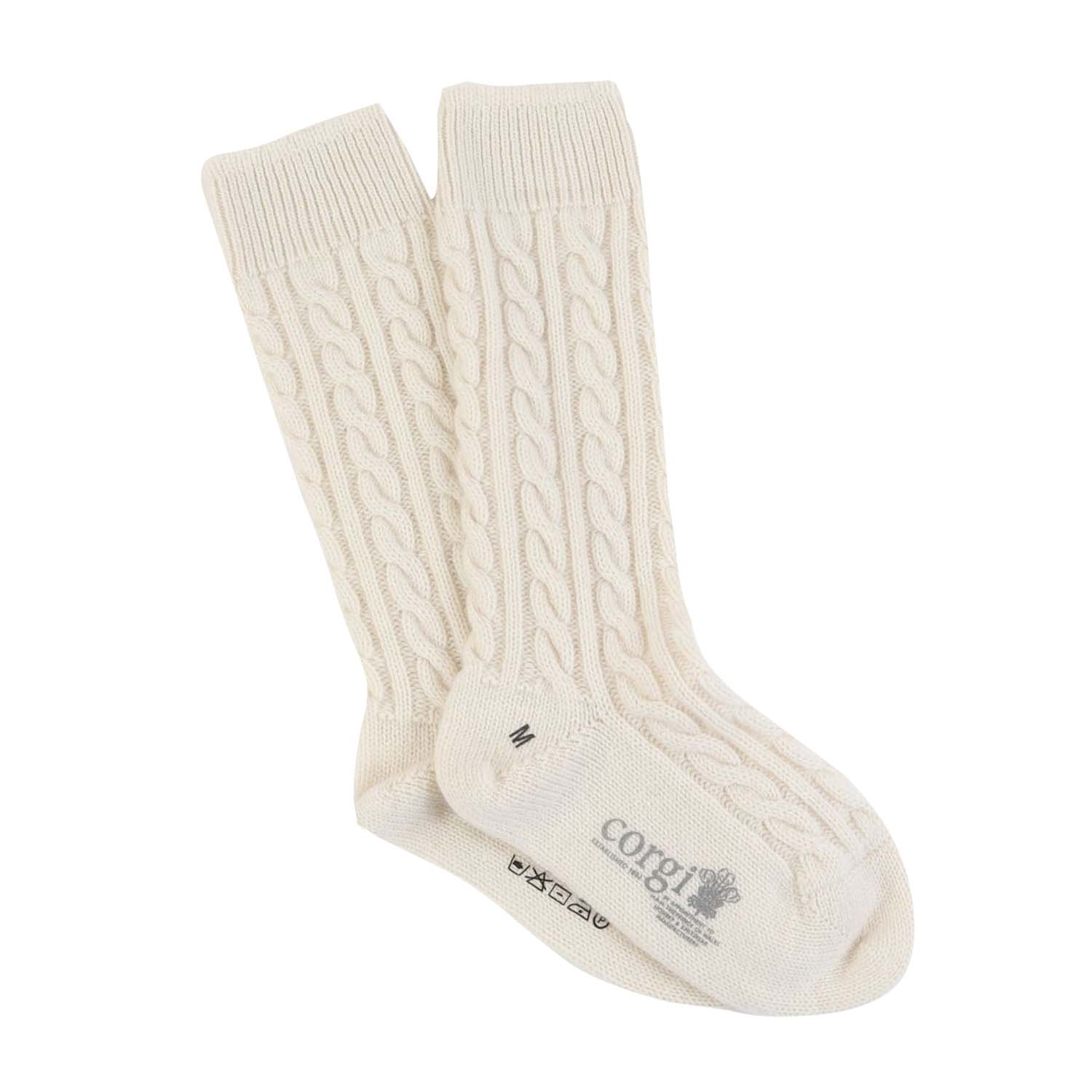 A pair of white cashmere socks with a cable knit pattern, displayed against a white background.