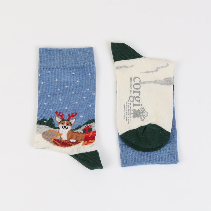 A pair of kids' Christmas themed cotton socks featuring a corgi dog design with holiday decorations and Corgi brand label.
